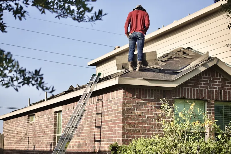 Professional roofer working on a residential roof in Fairview Heights